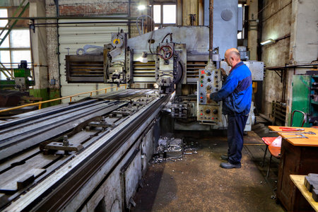 St. Petersburg, Russia - May 21, 2015: Planing and milling longitudinal machine tool, Machine tool operator planing and milling double column.のeditorial素材