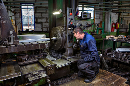 St. Petersburg, Russia - May 21, 2015: The operator controls the process of drilling the metal part on the horizontal boring machine.のeditorial素材