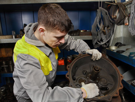 St. Petersburg, Russia - 22 December 2011: Repair shop forklifts, car mechanician assembles truck engine.のeditorial素材