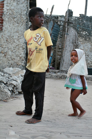 Zanzibar, Tanzania - February 20, 2008: Unidentified African children Muslims, walk the fishing village, a boy about 8 years old, and a girl about 4 years old.のeditorial素材