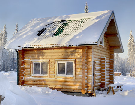 New wooden Russian bathhouse in a snowy winter forest, sunny day.のeditorial素材