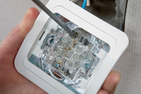 Repair wiring inside apartment, replacing wall light switch, close-up.