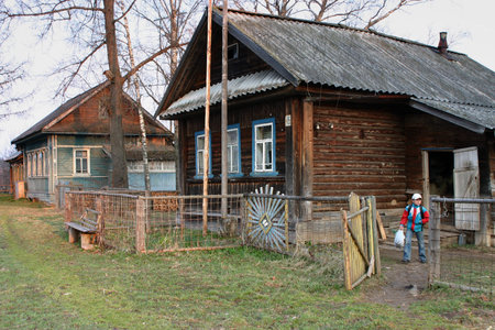 Lipovec village, Tver region, Russia - May 5, 2006: Rural girl Tanya 11 years old, coming out of the rural house in the early morning, in the spring to get a half kilometers to the school bus.のeditorial素材