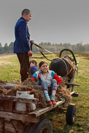 Lipovec village, Tver region, Russia - May 4, 2006:  Young villagers go to the cart horse-drawn.のeditorial素材