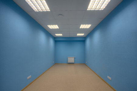 Small abandoned unfurnished office, no body, and no windows, the walls are painted in blue.のeditorial素材