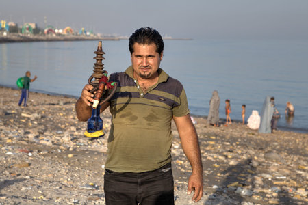Bandar Abbas, Hormozgan Province, Iran - 16 april, 2017: One unknown Iranian man shows a hookah on...