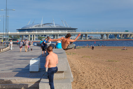 St. Petersburg, Russia - August 1, 2017: Park 300th anniversary of St. Petersburg, young man practicing parkour in the city park.のeditorial素材