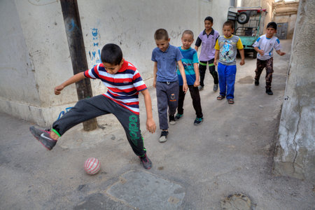 Fars Province, Shiraz, Iran - 18 april, 2017:  Iranian teenagers play football in the yard.のeditorial素材