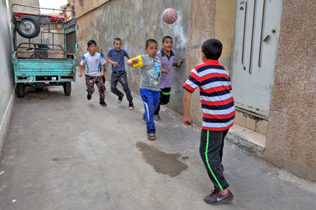 Fars Province, Shiraz, Iran - 18 april, 2017:  Iranian street boys playing soccer in yard.のeditorial素材