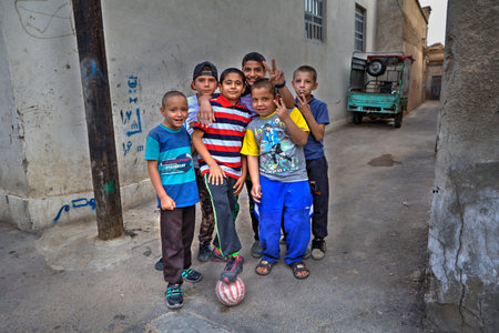 Fars Province, Shiraz, Iran - 18 april, 2017: Street children are posing for a photographer, a group portrait of a courtyard football team.のeditorial素材