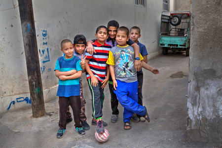 Fars Province, Shiraz, Iran - 18 april, 2017: Street children posing for a photograph, a group portrait of the yard football team.のeditorial素材