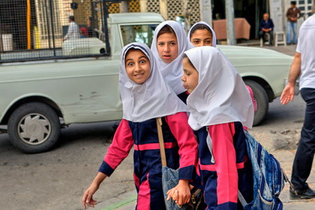 Fars Province, Shiraz, Iran - 18 april, 2017: Iranian girls in school uniform on a city street.のeditorial素材