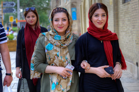 Fars Province, Shiraz, Iran - 18 april, 2017: Young Iranian women, dressed in hijab, are walking...