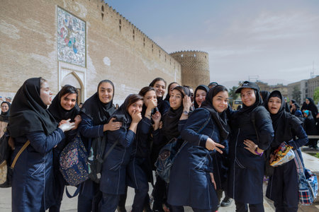 Fars Province, Shiraz, Iran - 19 april, 2017: Iranian schoolgirls are having fun and posing at the sight of a tourist's camera.のeditorial素材