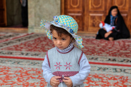 Fars Province, Shiraz, Iran - 19 april, 2017: Shah Cheragh Shrine, One unknown little girl, about 4 years old, in the inner courtyard of the mosque.のeditorial素材
