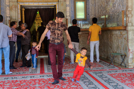 Fars Province, Shiraz, Iran - 19 april, 2017: Shah Cheragh Shrine, Father and son leave the mosque after prayer.のeditorial素材
