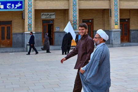 Fars Province, Shiraz, Iran - 19 april, 2017: Shah Cheragh Shrine, A Muslim clergyman passes through the courtyard of the mosque together with his young subordinate.のeditorial素材