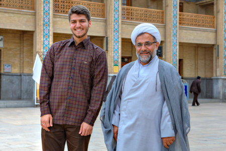 Fars Province, Shiraz, Iran - 19 april, 2017: Shah Cheragh Shrine, An elderly Muslim cleric in a white turban and his young companion posing for a photographer in the courtyard of the mosque.のeditorial素材