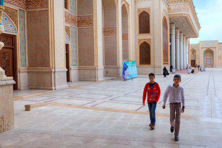Fars Province, Shiraz, Iran - 19 april, 2017: Shah Cheragh Shrine, Two Iranian teenagers cross the courtyard of the mosque.のeditorial素材