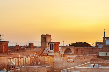 View of the city with traditional wind catchers towers on sunset, Yazd, Iran.の写真素材