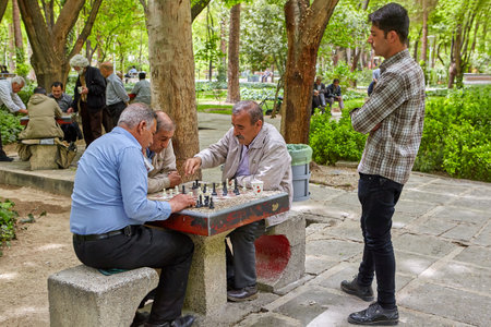 Isfahan, Iran - April 24, 2017: The old people are playing chess in the city park.のeditorial素材