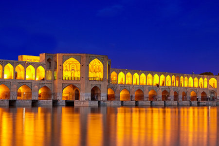 Isfahan, Iran - April 24, 2017: Night illumination of the arched stone Khaju bridge, crossing the Zayandeh river.のeditorial素材