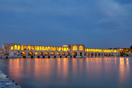 Isfahan, Iran - April 24, 2017: Evening illumination of the arched pedestrian Khaju bridge across the Zayandeh river.のeditorial素材