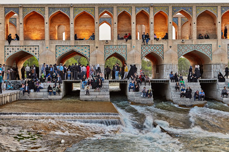 Isfahan, Iran - April 24, 2017: Iranians are sitting on the steps of the Khaju bridge at twilight waiting for the sunset.のeditorial素材