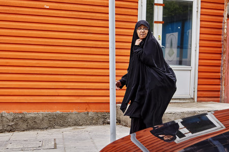 Tehran, Iran - April 28, 2017: Iranian woman in hijab is walking on city street.のeditorial素材