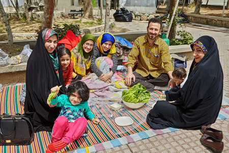 Tehran, Iran - April 28, 2017: big Iranian family is spending a day off making a picnic in the park, they are smiling and laughing.のeditorial素材