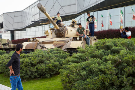 Tehran, Iran - April 28, 2017: Iranian men and boy make photos in Holy Defense Museum with exhibits concerning the 8 year Iran-Iraq War.のeditorial素材