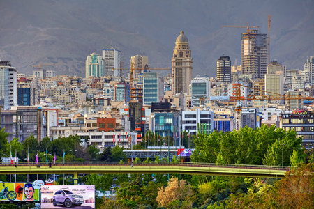 Tehran, Iran - April 28, 2017: A view of the pedestrian Abo Atash bridge and multi-storey buildings of northern Tehran in the background of the mountains.のeditorial素材
