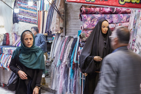 Tehran, Iran - April 29, 2017: Departments with clothes and fabrics on the Tehran Grand Bazaar, buyers pass by.のeditorial素材