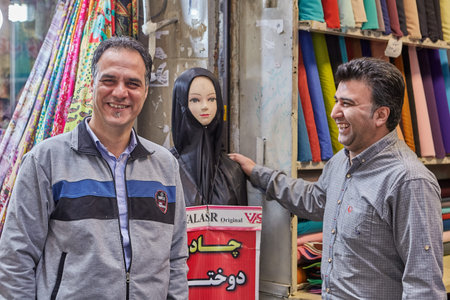 Tehran, Iran - April 29, 2017: Iranian fabric sellers joke about the female dummy in a black religious veil.のeditorial素材