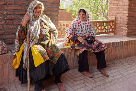 Abyaneh, Iran - April 26, 2017: two elderly Iranian women are sitting and smiling in a traditional village in the mountains.のeditorial素材