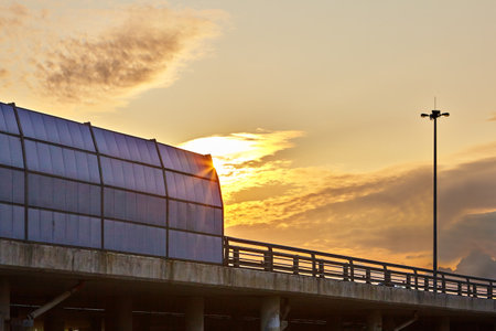 St. Petersburg, Russia - August 28, 2018: highway sound proof barrier panel of the ring road from outside in the setting sun.のeditorial素材