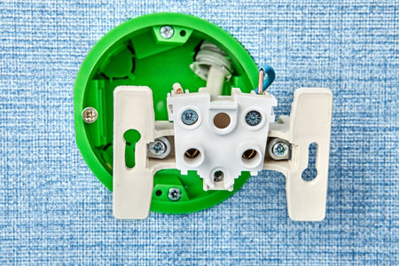 Fixing of loose electrical outlet in round plastic box.