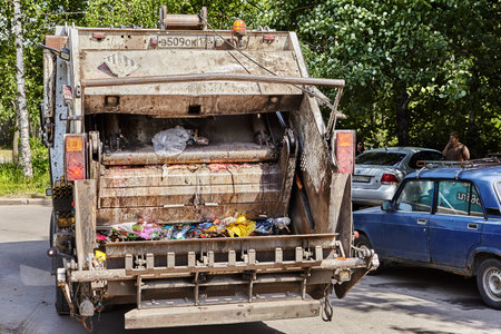 St. Petersburg, Russia - June 17, 2019: The garbage truck leaves the trash containers place and goes to the landfill.のeditorial素材