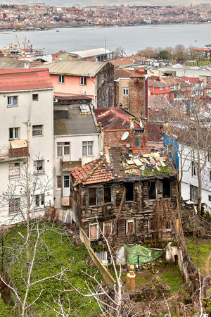 Istanbul, Turkey - February 12, 2020: A view of the Golden Horn Bay and dilapidated wooden house in the Beyoglu area.のeditorial素材