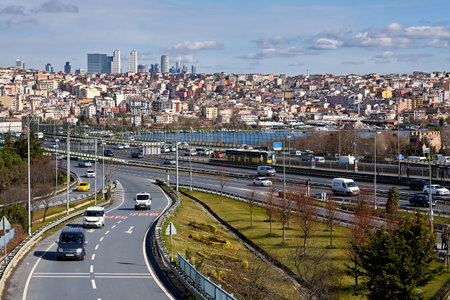 Istanbul, Turkey - February 12, 2020: Cars drive off the Halich Bridge over Golden Horn with the Beyoglu district in the background.のeditorial素材