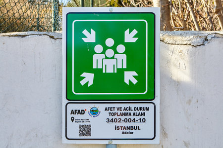 Istanbul, Turkey - February 13, 2020: Emergency assembly point sign on a fence wall on Buyukada island, one of the Prince islands in the Adalar District.のeditorial素材