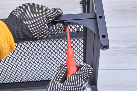 Building flat packed furniture DIY with help of screwdriver at home.