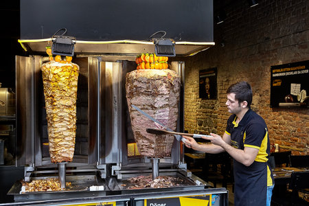 Istanbul, Turkey - February 14, 2020: Seller of doner kebabs the dish containing meat cooked on a vertical spit.のeditorial素材
