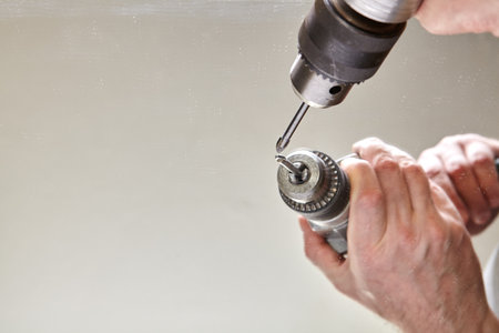 Glass drill bit is clamped in chuck for drilling hole in mirror.の写真素材