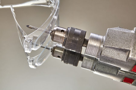 Drill pierced surface of goggles, an industrial accident.