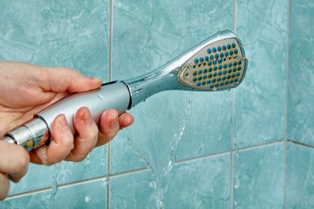 Replacing an old broken shower head in the bathroom.