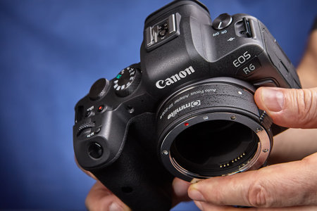 St. Petersburg, Russia - January 9, 2021: Commlite Ef-eos R electronic Af lens mount adapter from...