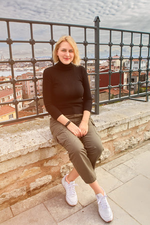 Istanbul, Turkey - young white woman posing for photographer in Fatih area.