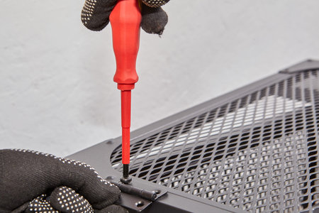 Furniture with metal frame is assembled with screwdriver.