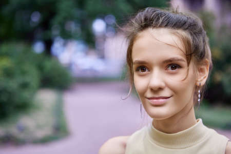 Brown eyed Caucasian woman 18 years old, close-up street portrait.の写真素材